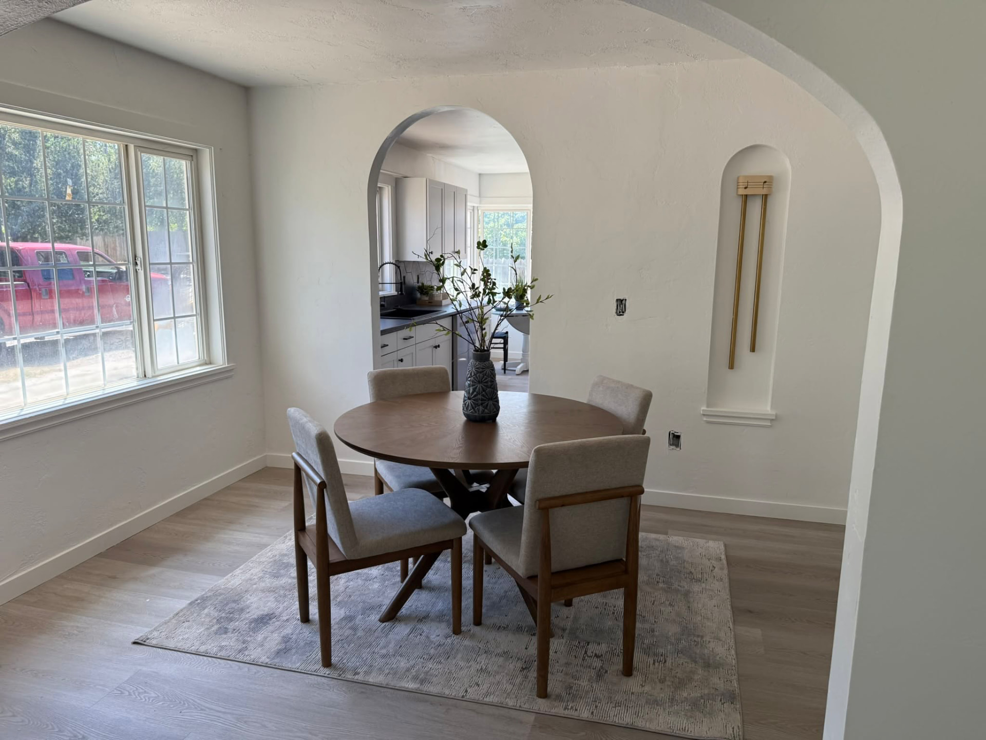 Dining room with arched doorway to the kitchen