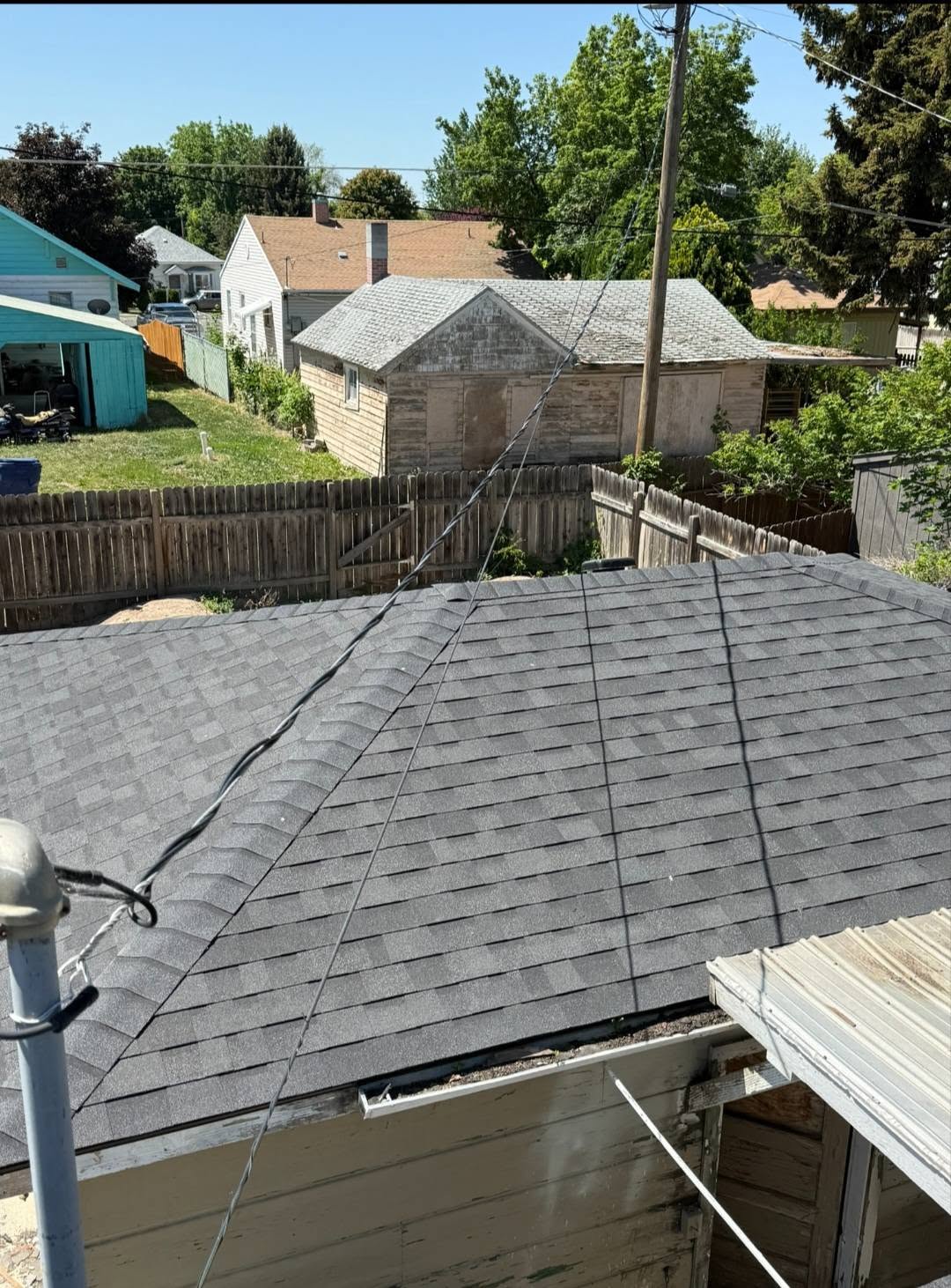Roof and backyard from an elevated jobsite view