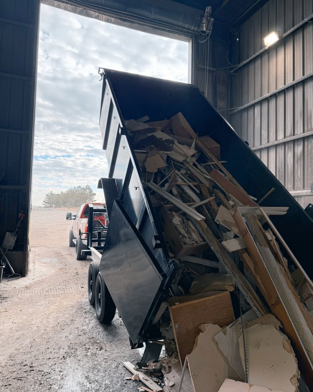 Dump trailer clearing demolition debris